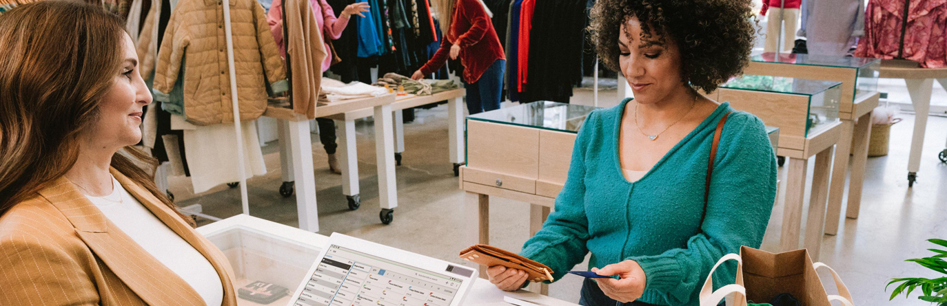 A woman making a transaction at a store.